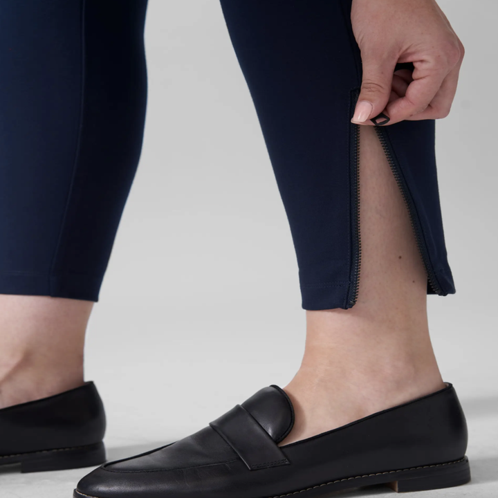 close-up showing model zipping the bottom of the pant leg