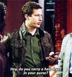 gif of Jake Peralta from Brooklyn 99 asking someone out of frame, hey, do you carry a hair dryer in your purse