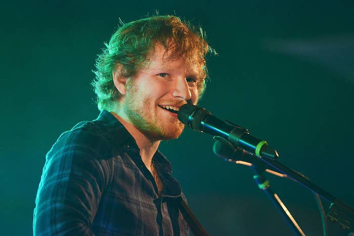 Ed smiles as he performs onstage