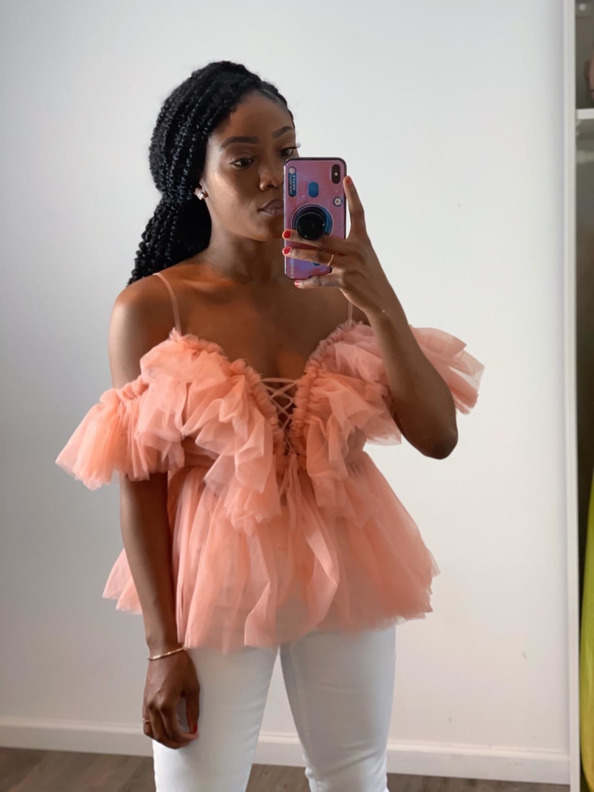 Reviewer wearing top in pink