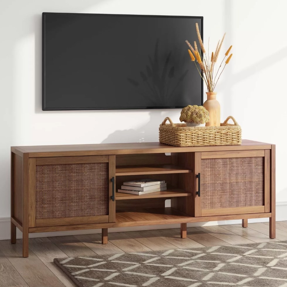 A brown tv stand with two cabinets and three shelves