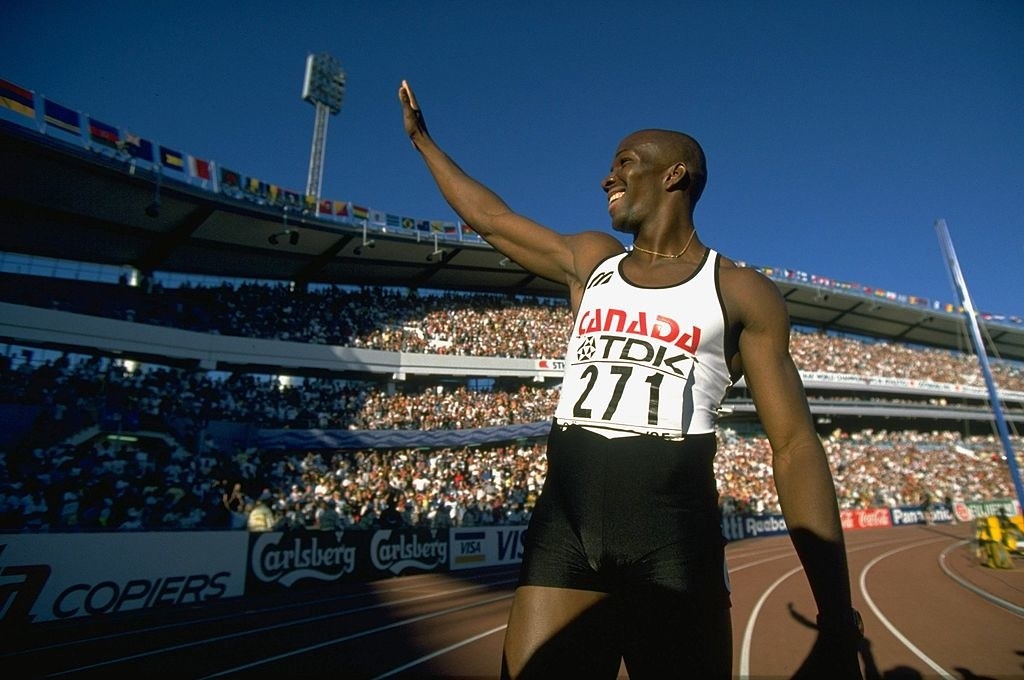 Donovan Bailey waving to the crowd at the 1995 IAAF World Championships as he stands on the track