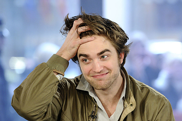back in 2009, Rob runs his fingers through his long and surely clean hair