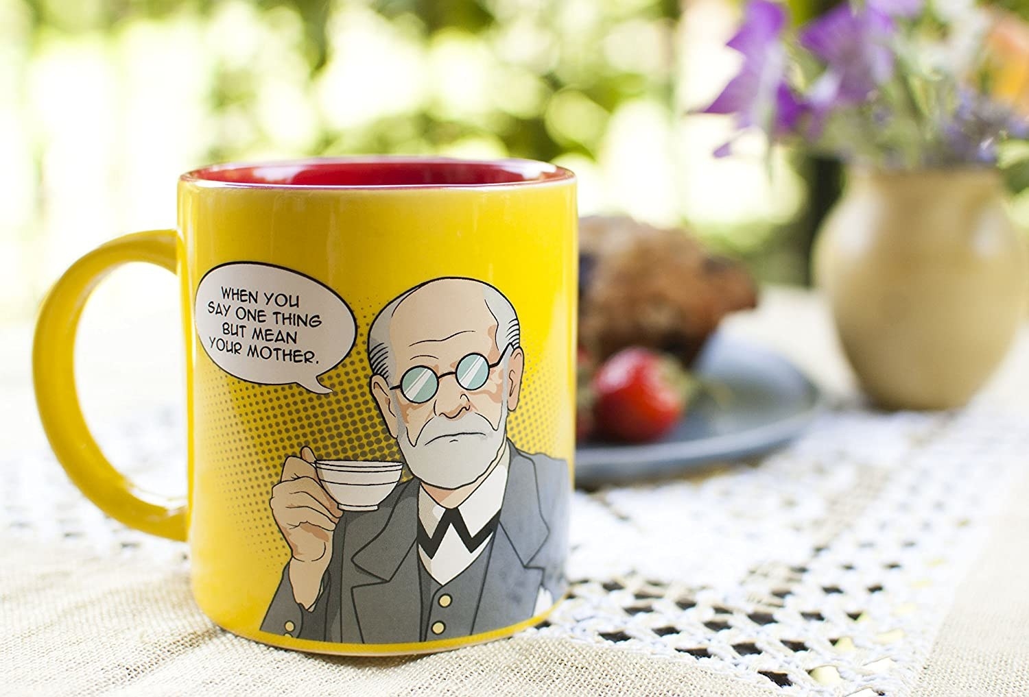 The mug with a comic rendition of Sigmund Freud holding a teacup, with a speech bubble saying, when you say one thing but mean your mother