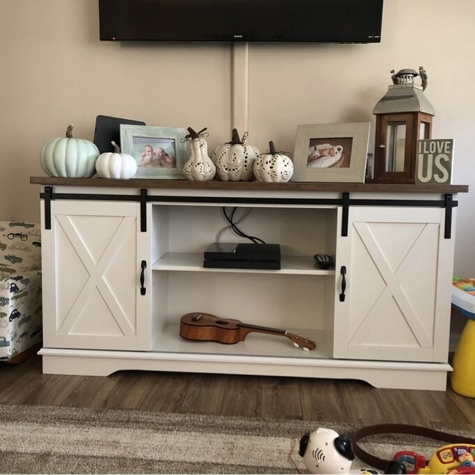 the entertainment console filled with decor