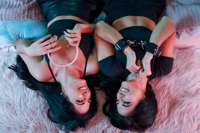 two women laying back on a fuzzy rug and smiling