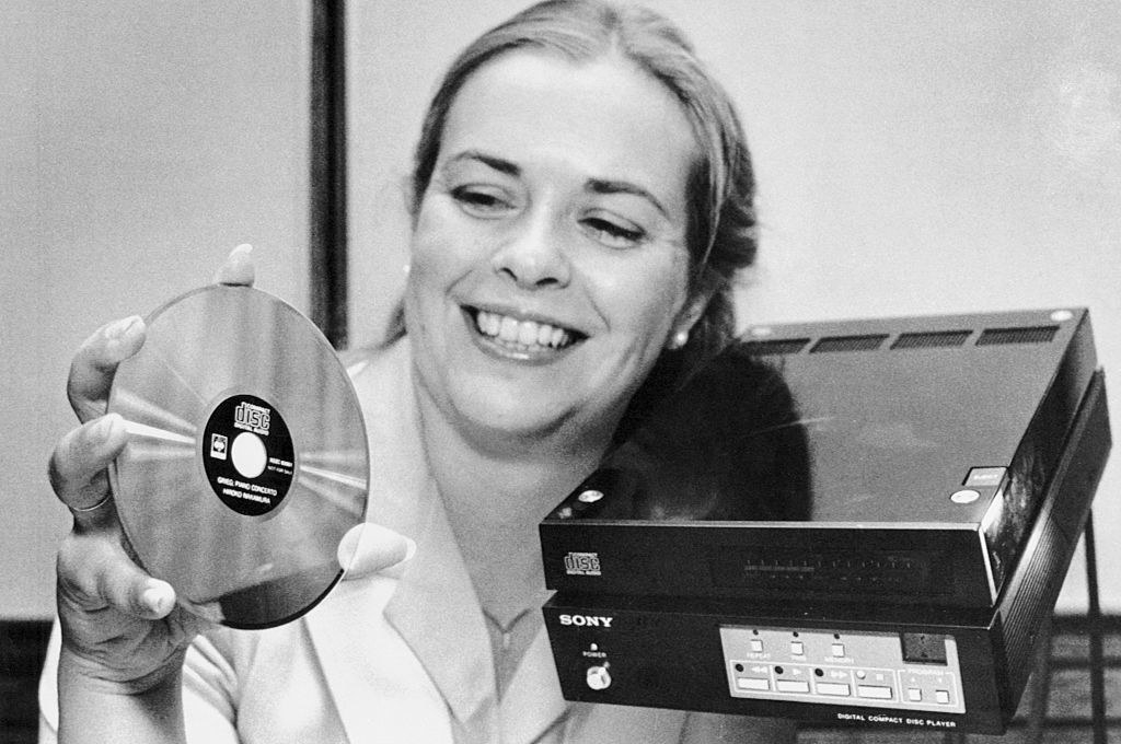 woman holding a cd player and cd in 1982