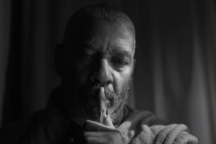 Denzel Washington is posing as Macbeth with his finger on his lip