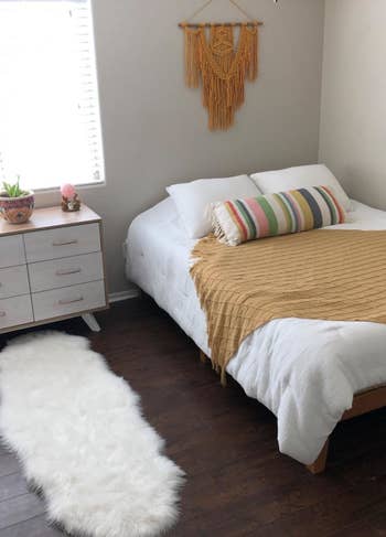 a reviewer's bedroom with the white rug by the dresser