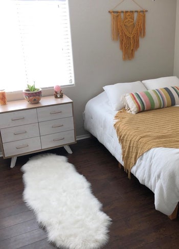a reviewer's bedroom with the white rug by the dresser