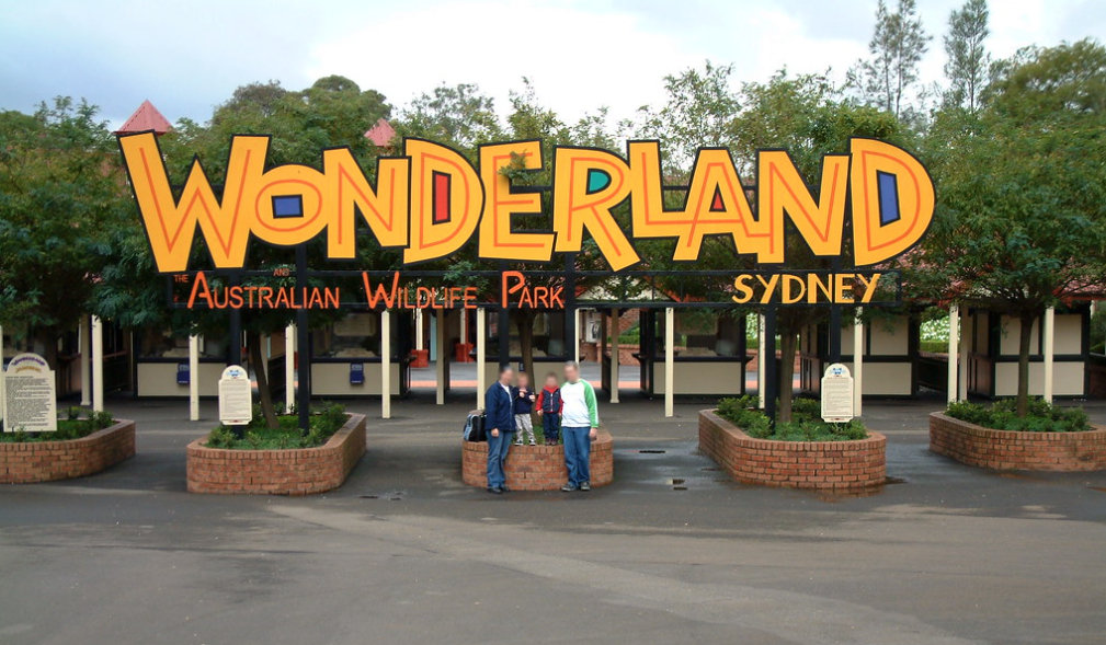 A family posing in front of Australia&#x27;s Wonderland theme park sign