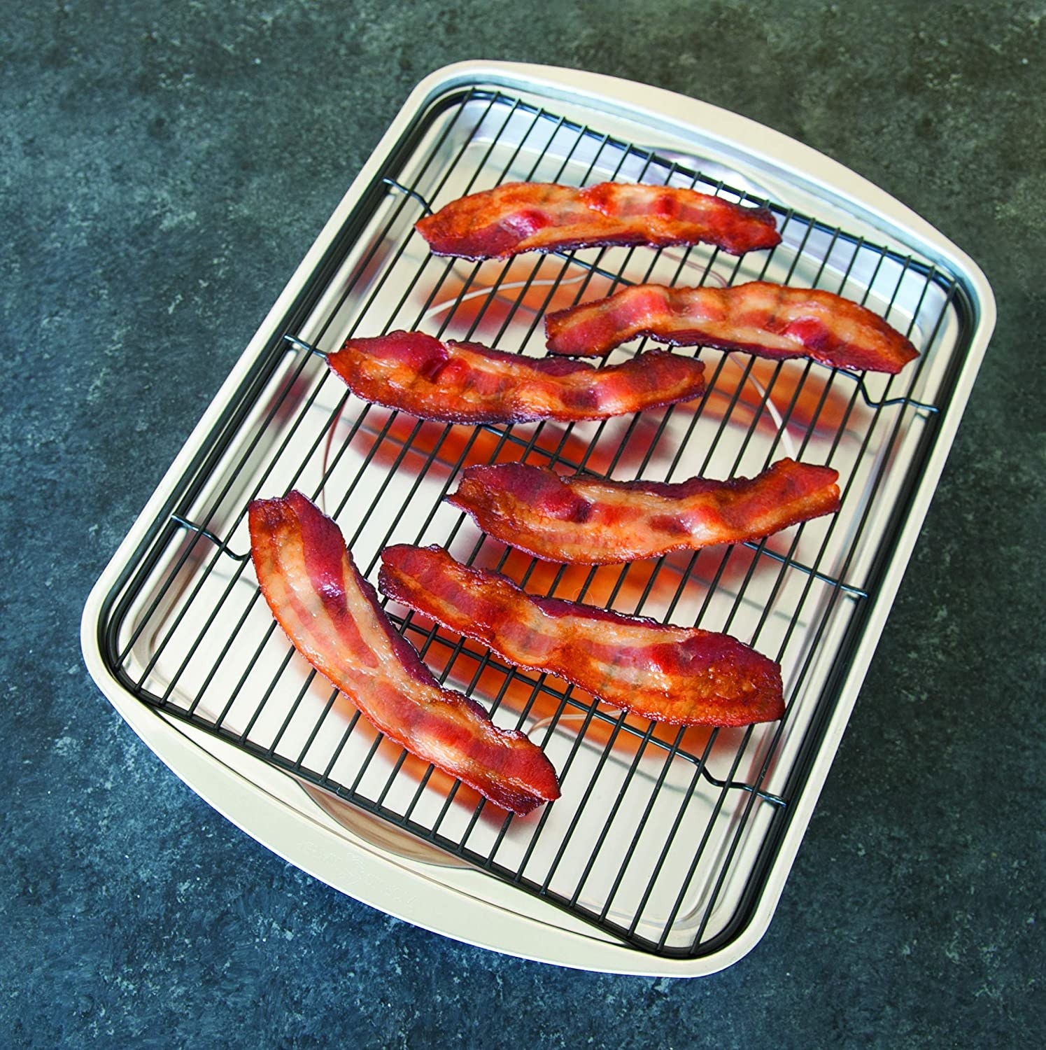Several strips of bacon on the bacon pan