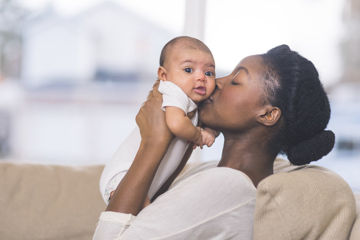 Mother kissing her baby