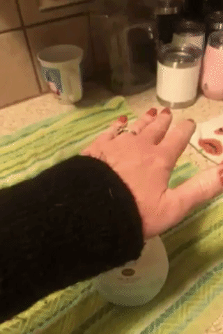 a gif of a reviewer using the bottle of the soap to show paw-shaped soap