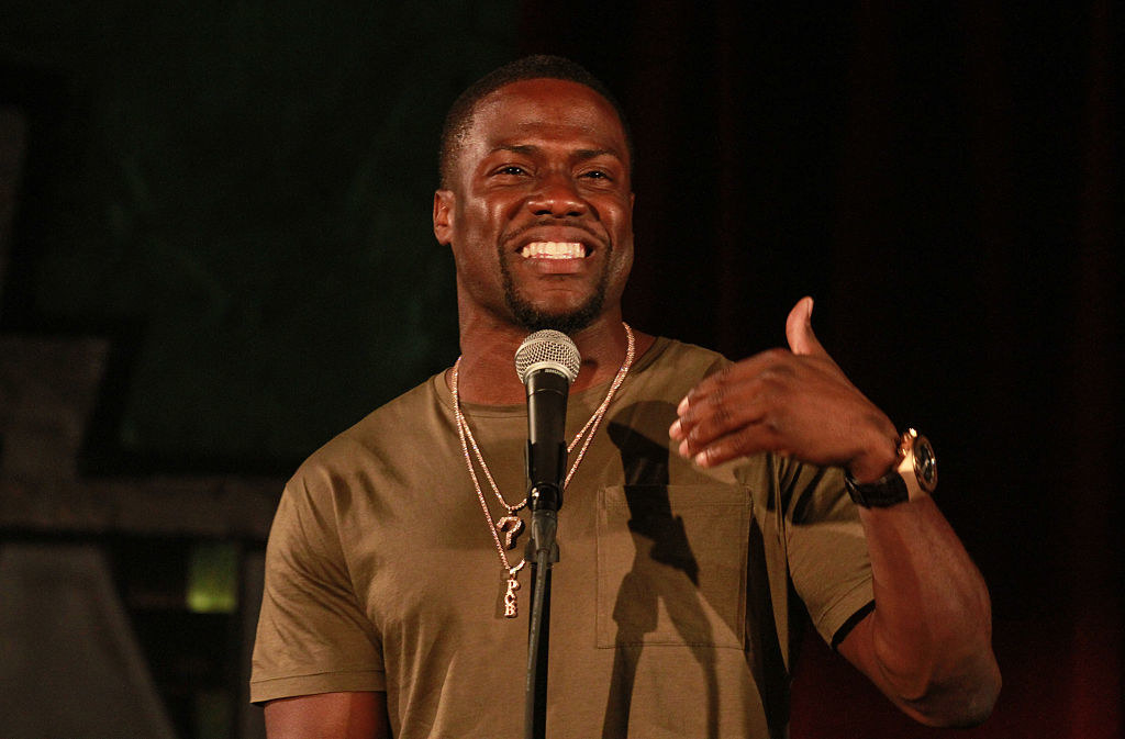 Kevin Hart smiling at a microphone