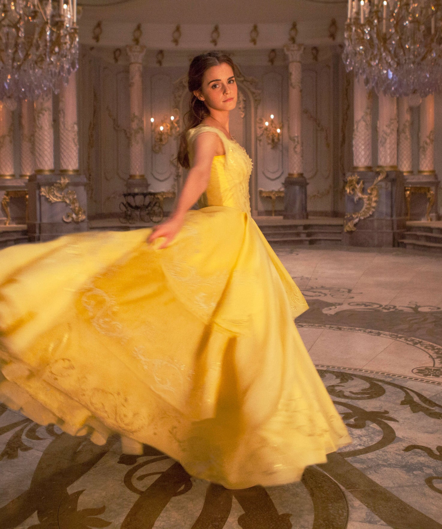 Belle stands with her flowing gown