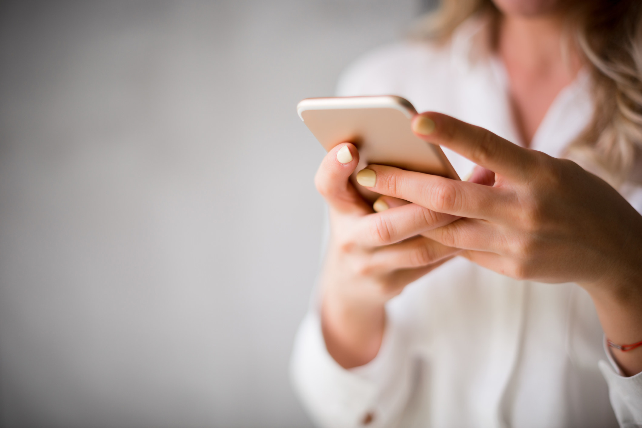 Close up of a woman using her smartphone indoors