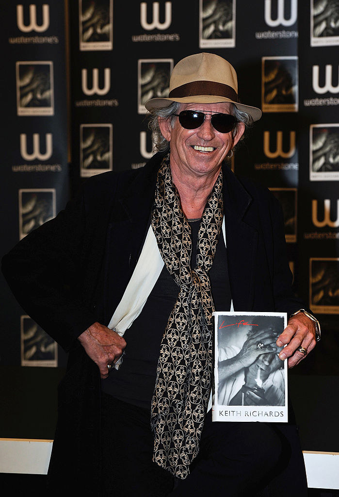 Keith Richards holding his book at a signing