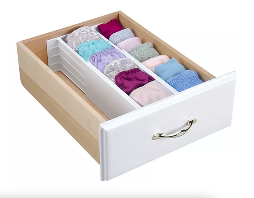 Expandable organizers shown separating socks and underwear in a drawer