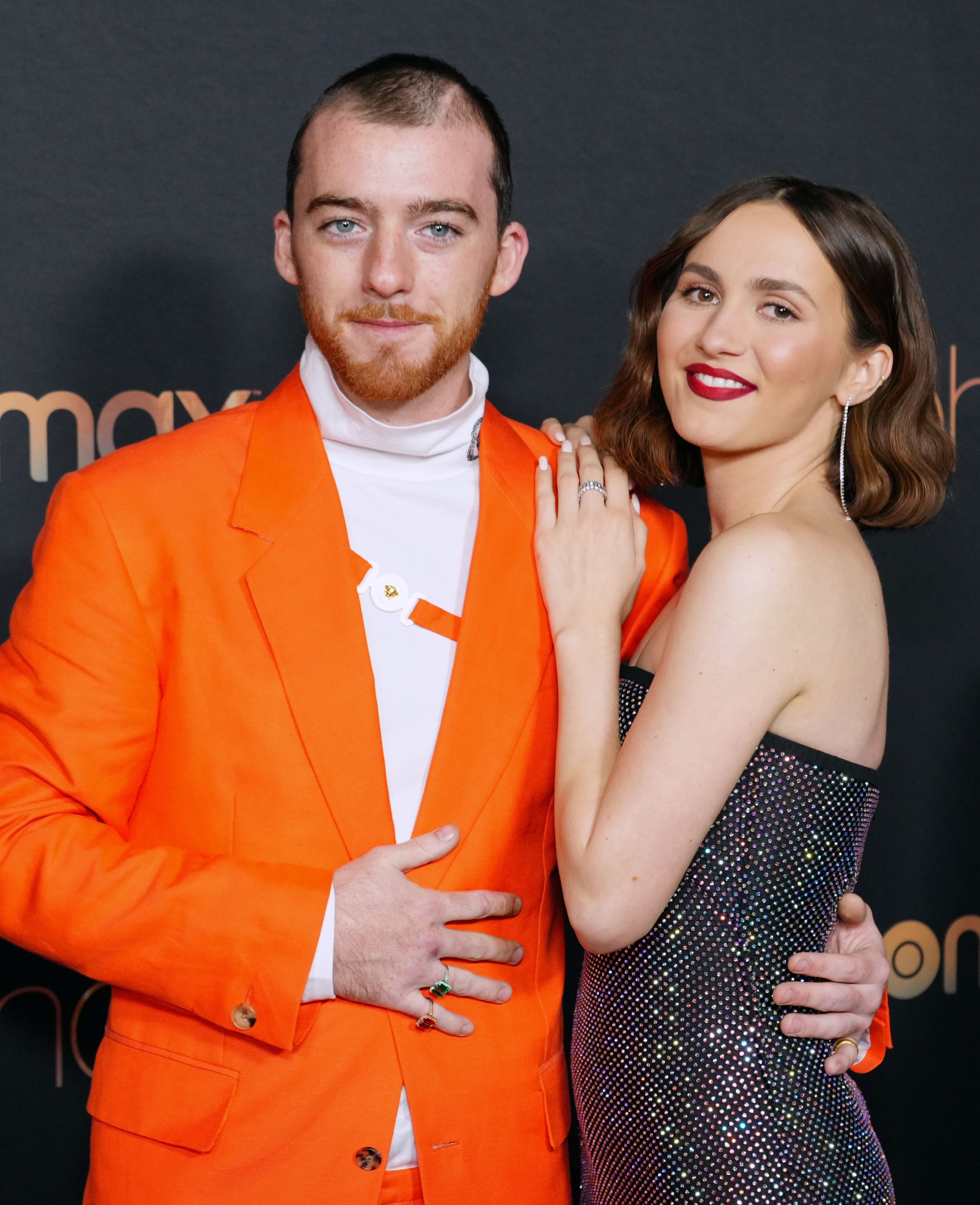 Angus and Maude embracing on the red carpet