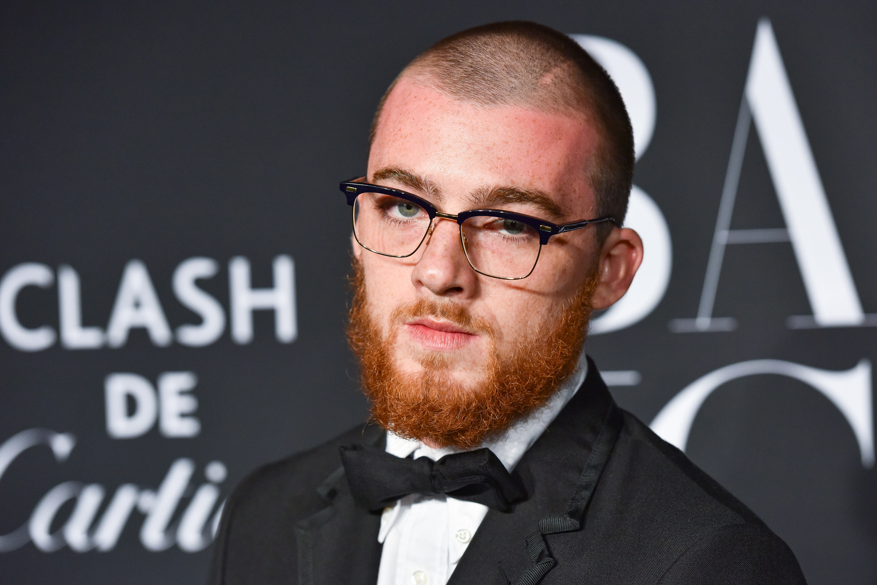 Angus in a bow tie and glasses on the red carpet