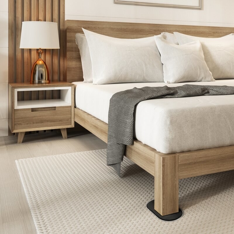 An image of a furniture sliders placed underneath a bed frame