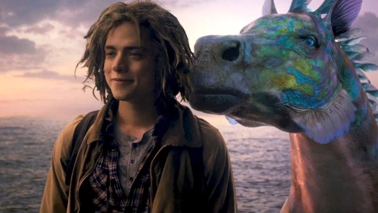 a CGI sea creature comes behind a scraggly boy wearing a light jacket, long messy hair and a backpack