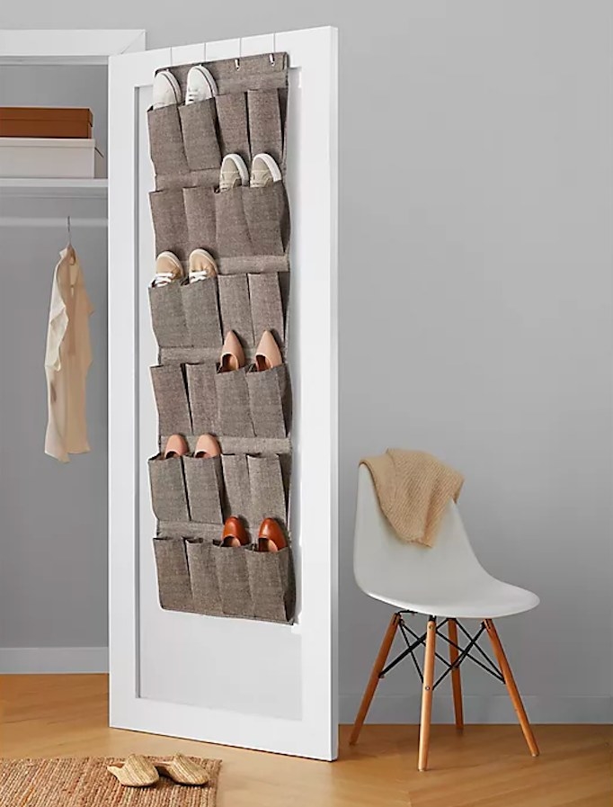 Gray shoe organizer hanging on the inside of a closet door