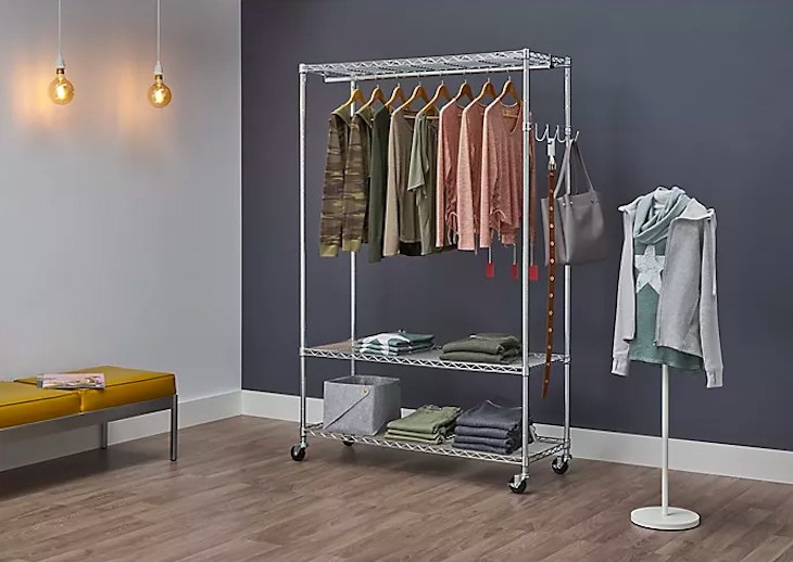 Rolling rack filled with clothes in a room