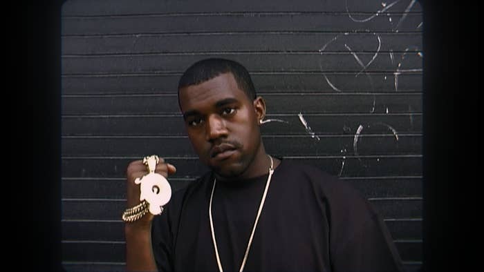A younger Ye wearing holding up a gold chain