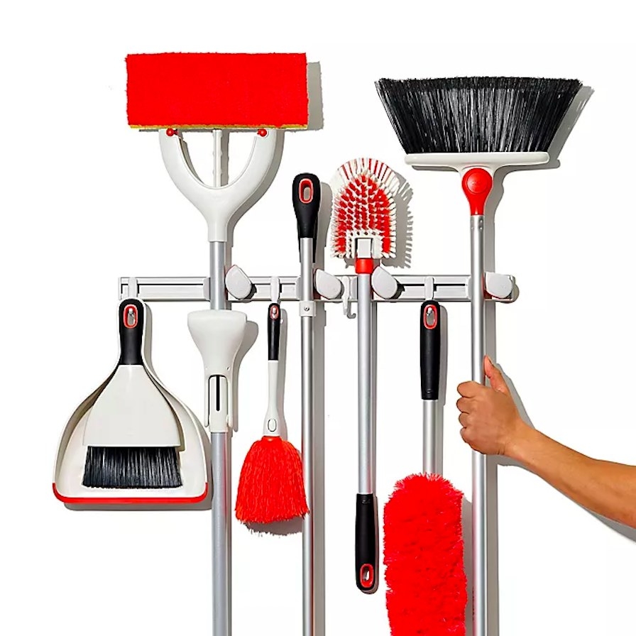 Various cleaning tools hung up on organizer