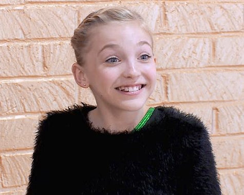 A young and excited Brynn dressed in black