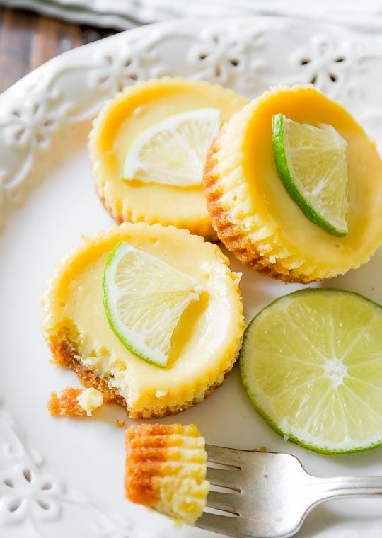 Mini key lime pies with a bite taken out of one.