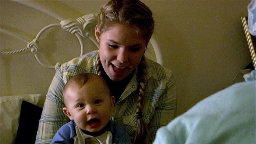 baby isaac and kailyn smiling on a bed