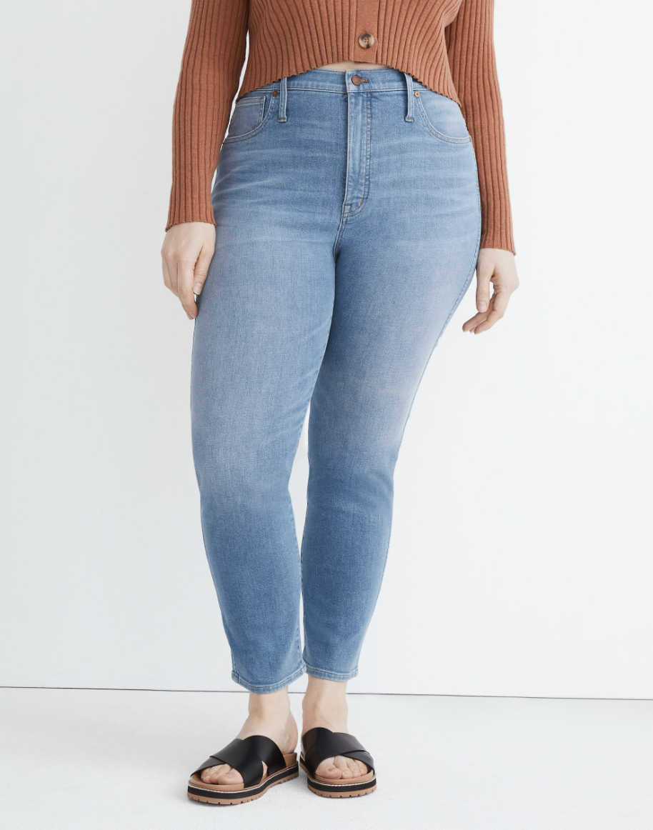 model in light wash stovepipe high-waisted jeans