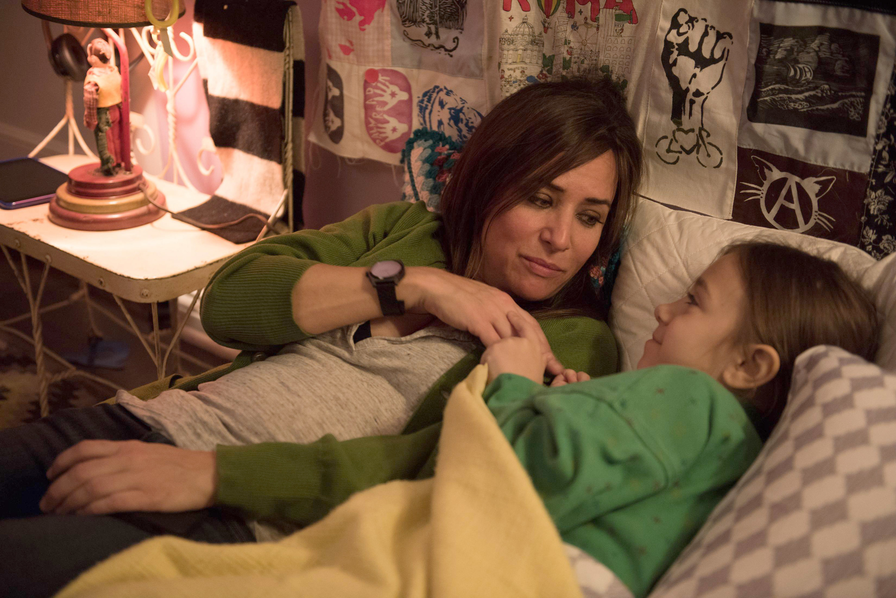 Pamela Adlon and Olivia Edward lying on a bed together in &quot;Pilot&quot;