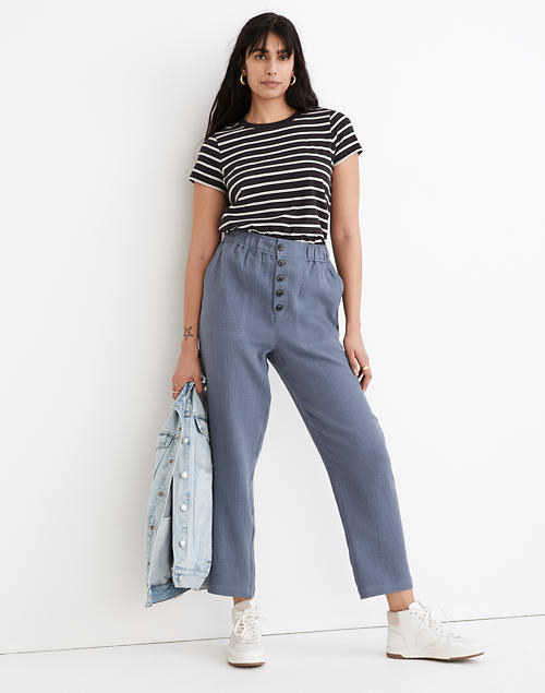 model wearing the blue linen pants with a striped tee and sneakers