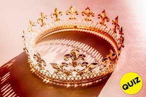 A rose gold crown sits on a pink seamless.