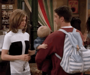 Ross hands Rachel baby Ben and she holds him out in front of her with her hands on his ribs, so uncomfortable