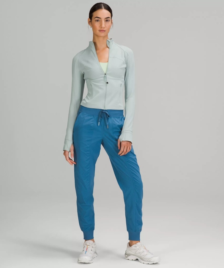 A model wearing a pair of mid-rise joggers in light blue