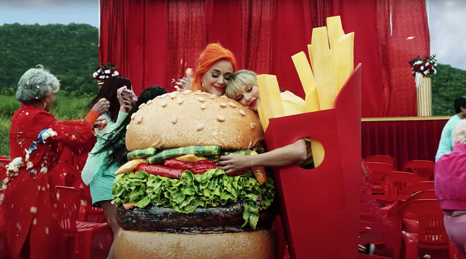 Katy Perry in a hamburger suit is hugged by Taylor Swift in french fry suit in the &quot;You Need to Calm Down&quot; music video