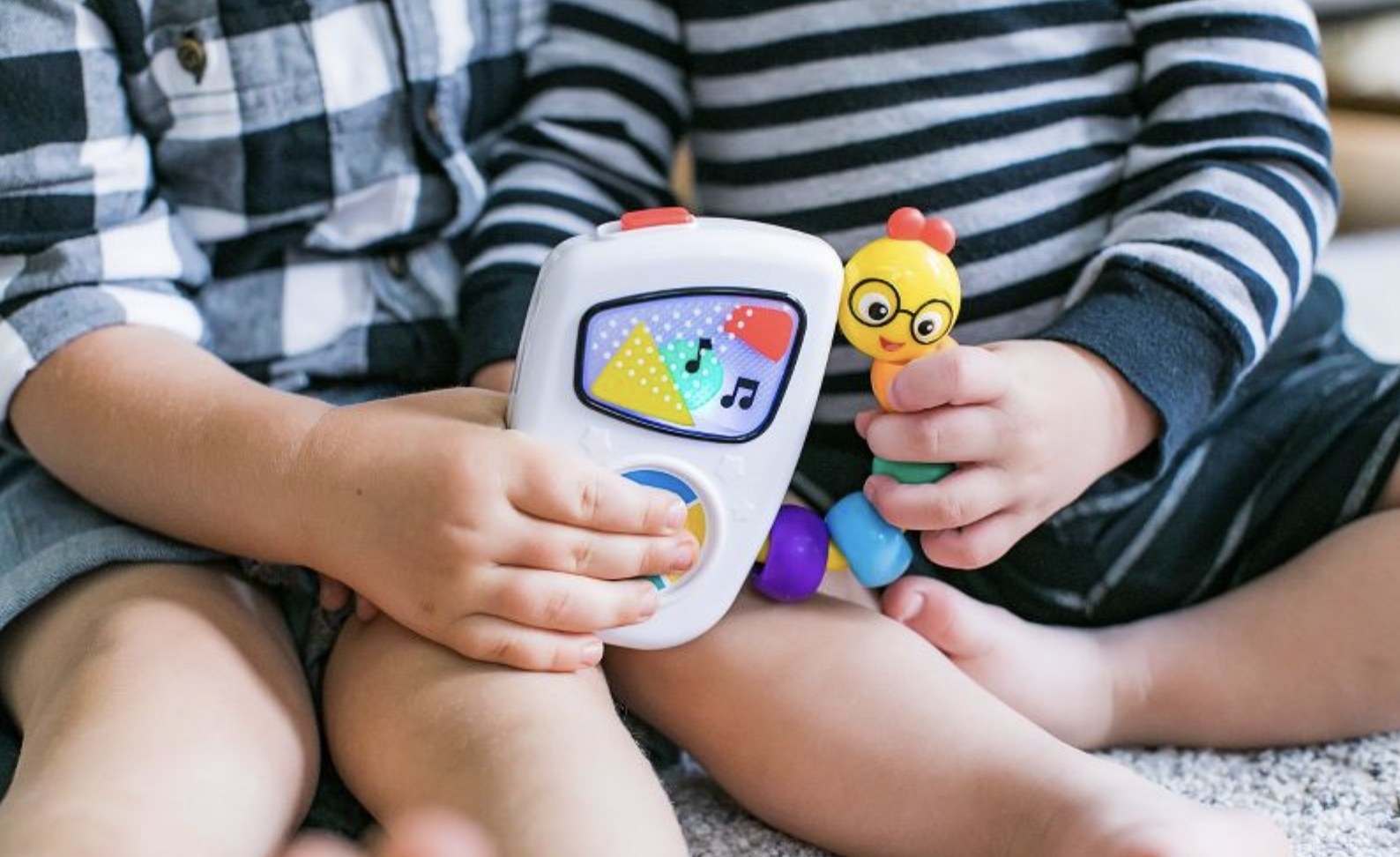 Kids holding Baby Einstein Take Along Tune