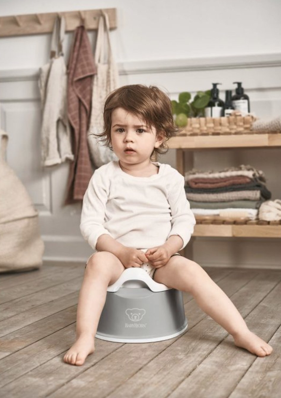 Baby sitting on travel potty