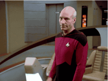 Sir Patrick Stewart as Jean-Luc Picard waving in Star Trek: TNG