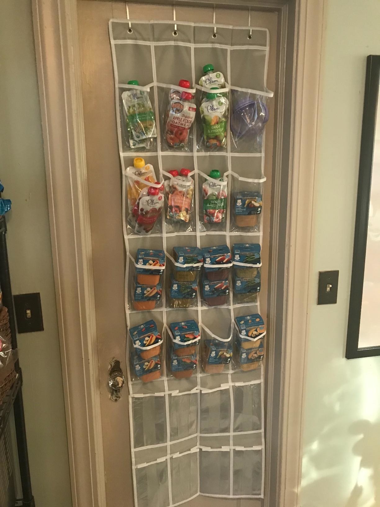 reviewer&#x27;s photo of their baby food pouches and jars in the shoe organizer