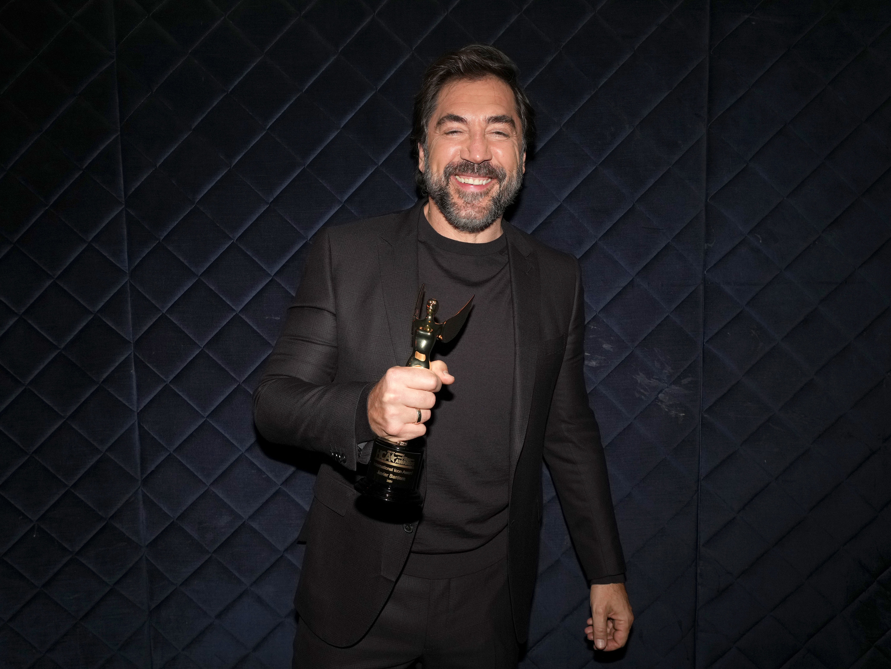 Javier holds a statue backstage