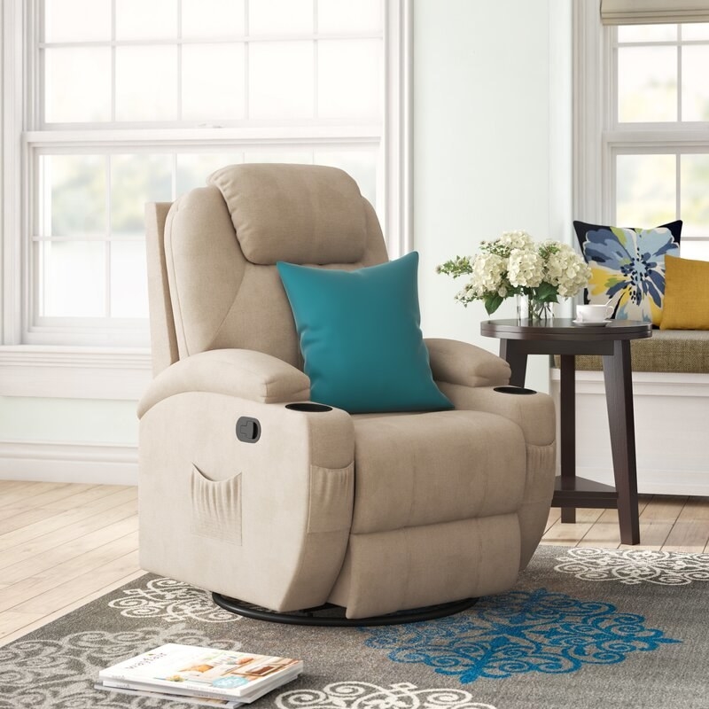 Beige massage chair with blue pillow on it