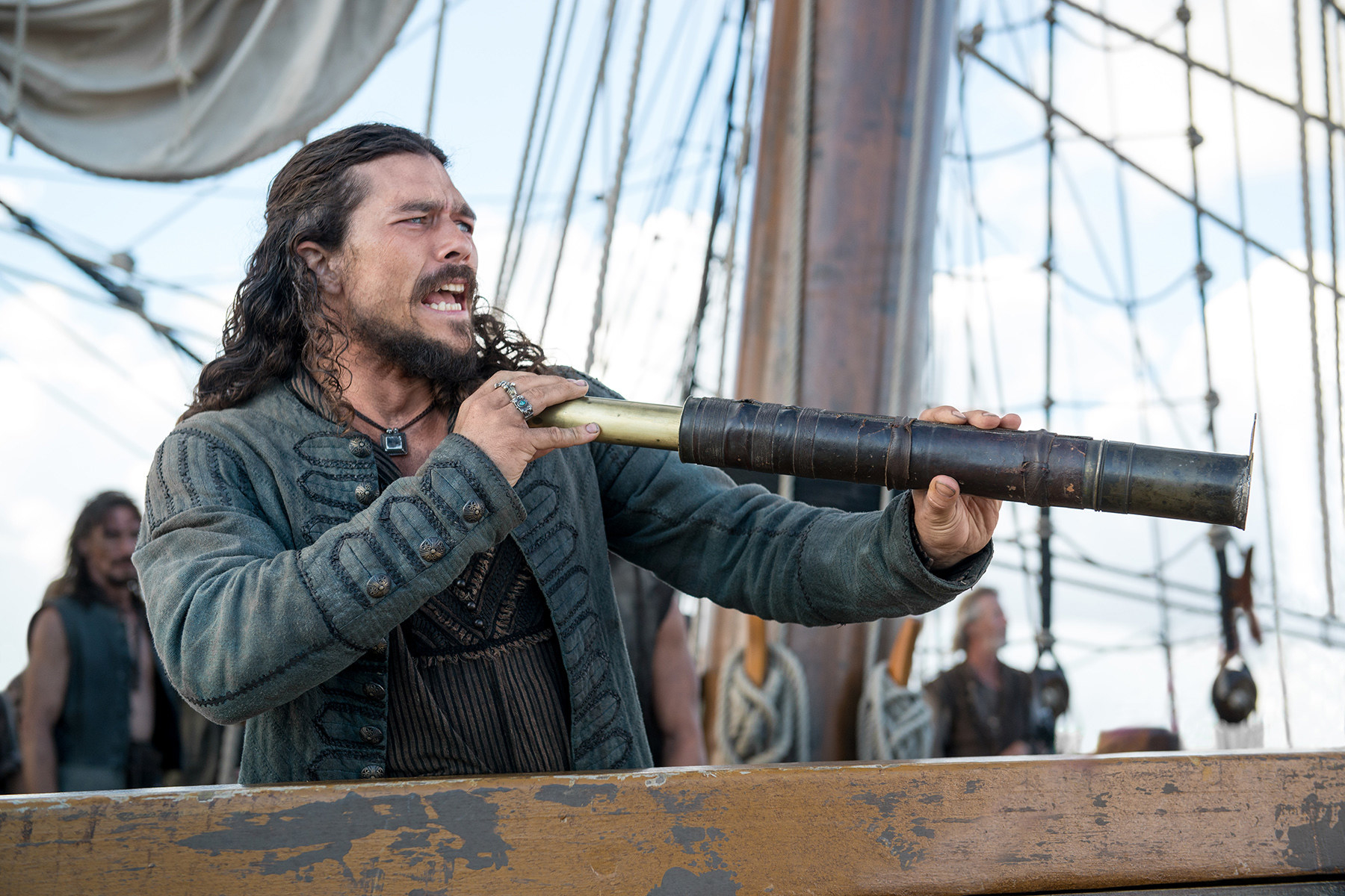 Long John Silver holding a telescope on a pirate ship