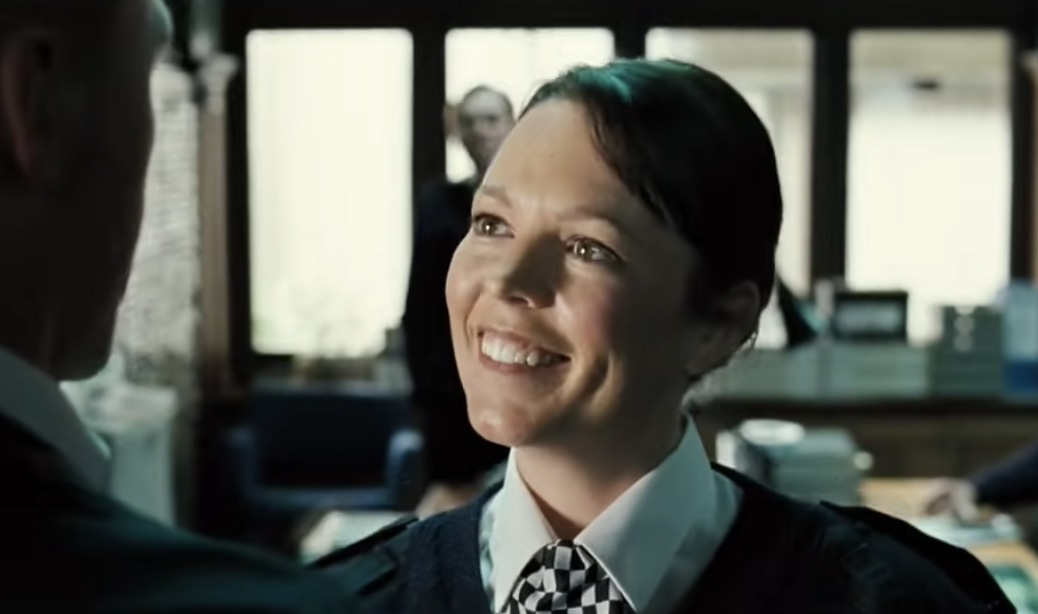 Olivia Colman smiling at Simon Pegg