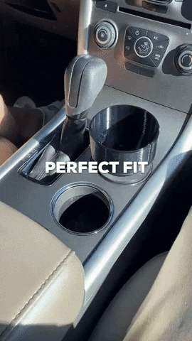 A gif of someone putting their large water bottle into their car&#x27;s cup holder using the adapter